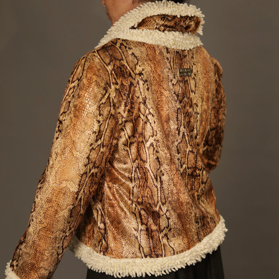 Editorial close-up of the jacket’s python texture and cream shag hem, emphasizing craftsmanship.