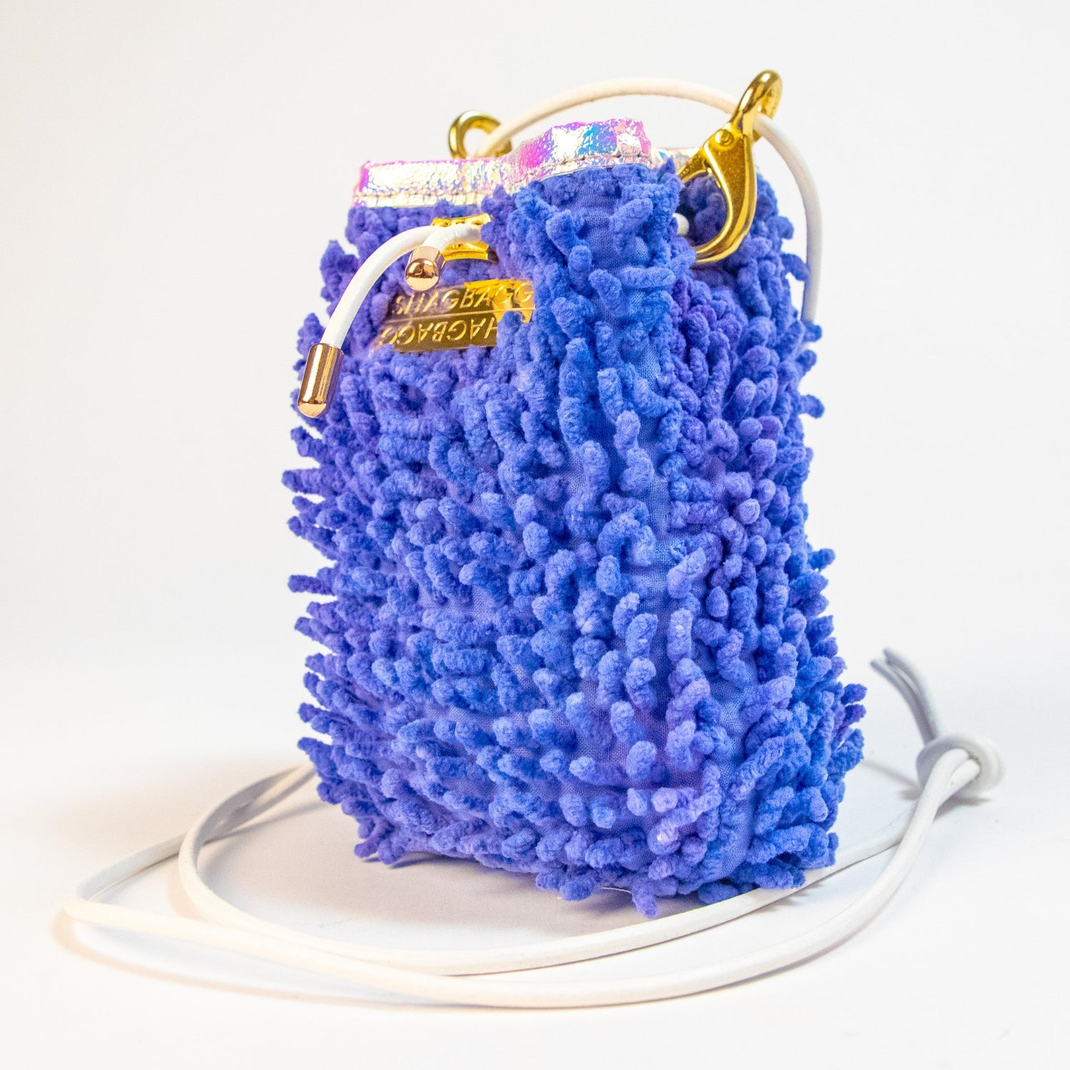 SHAGBAGG Drawstring SHAG Mini in Disco Queen Purple, three quarter angle showing iridescent holographic vinyl trim and gold hardware