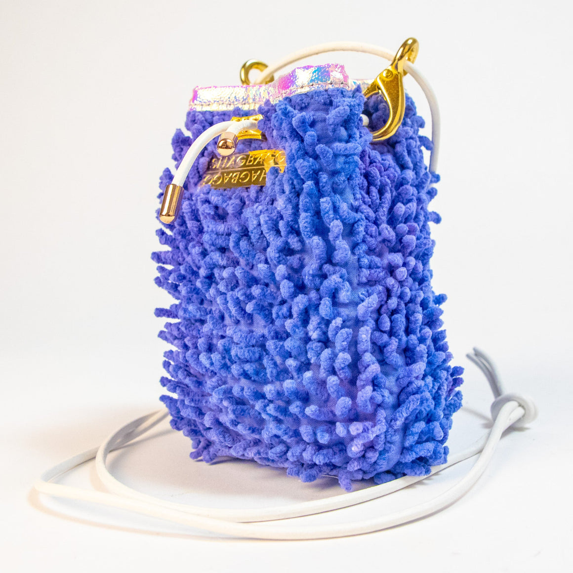 SHAGBAGG Drawstring SHAG Mini in Disco Queen Purple, three quarter angle showing iridescent holographic vinyl trim and gold hardware