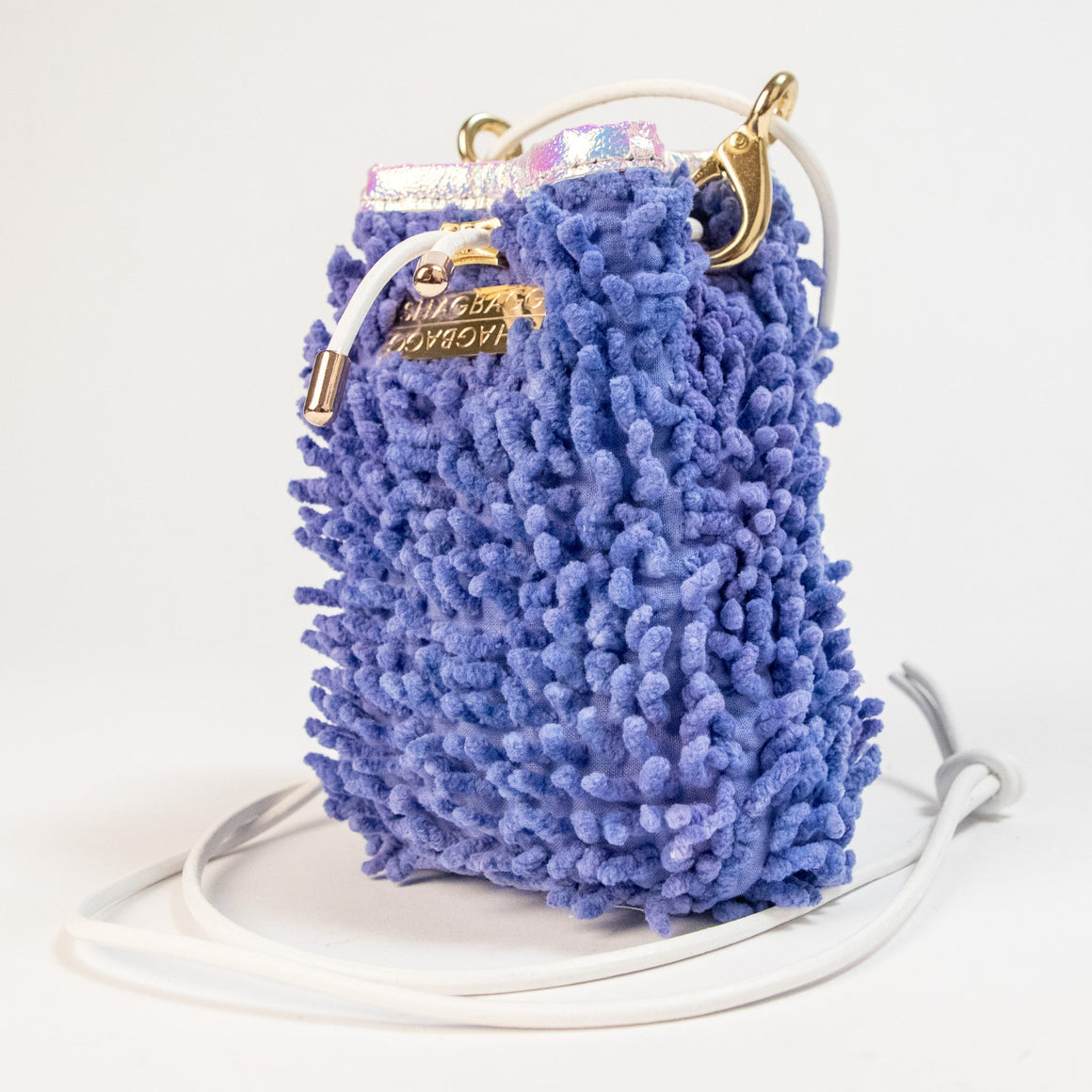 SHAGBAGG Drawstring SHAG Mini in Disco Queen Purple, three quarter angle showing iridescent holographic vinyl trim and gold hardware