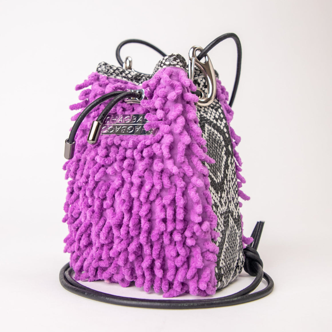 SHAGBAGG Drawstring Mini — Electric Orchid purple SHAG and black white faux python 3 panel crossbody bag with silver hardware and black leather cord, handmade Hollywood Los Angeles, front view