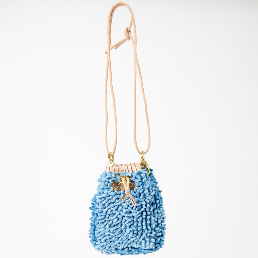SHAGBAGG Drawstring Mini — Indigo Sister No. 1, cornflower blue full SHAG crossbody bag with gold hardware and blush croc collar, handmade Hollywood Los Angeles, front view