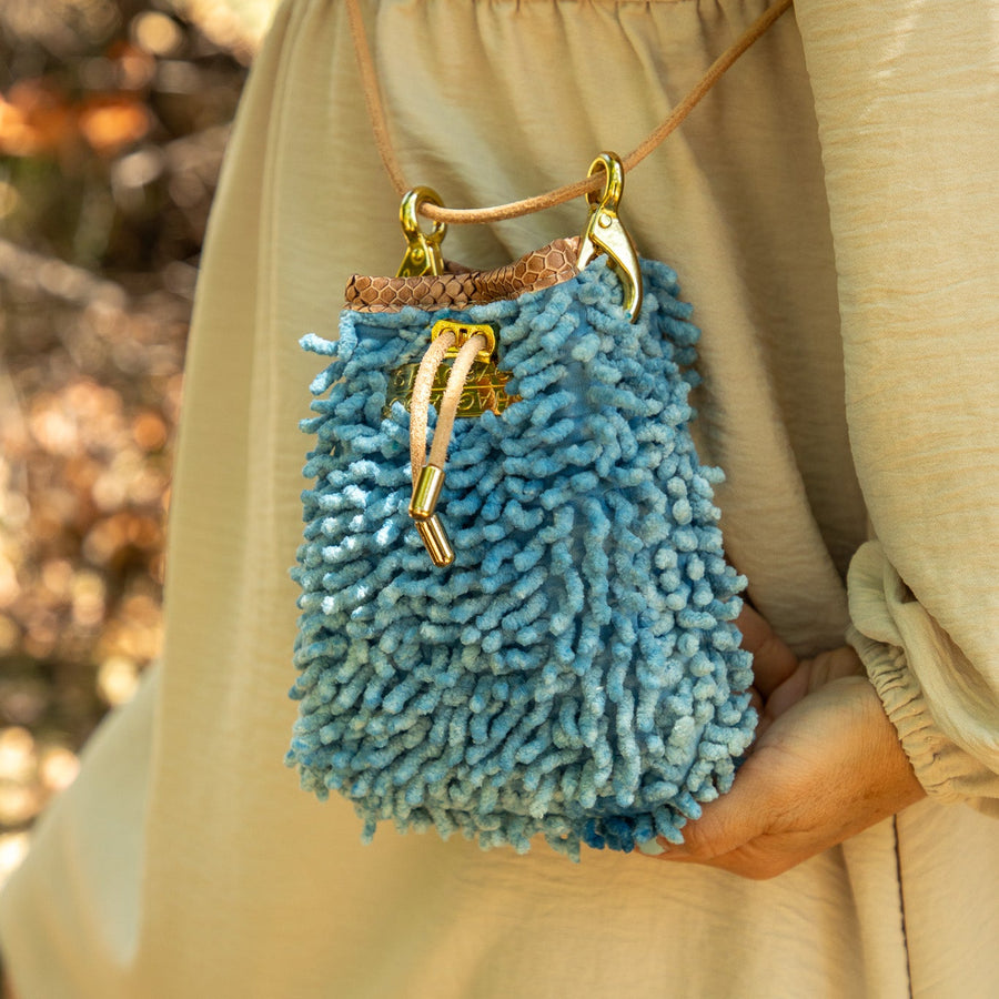 SHAGBAGG Drawstring Mini — Indigo Sister No. 3, vintage denim cornflower blue full SHAG crossbody bag with gold hardware and blush python collar, handmade Hollywood Los Angeles, front view