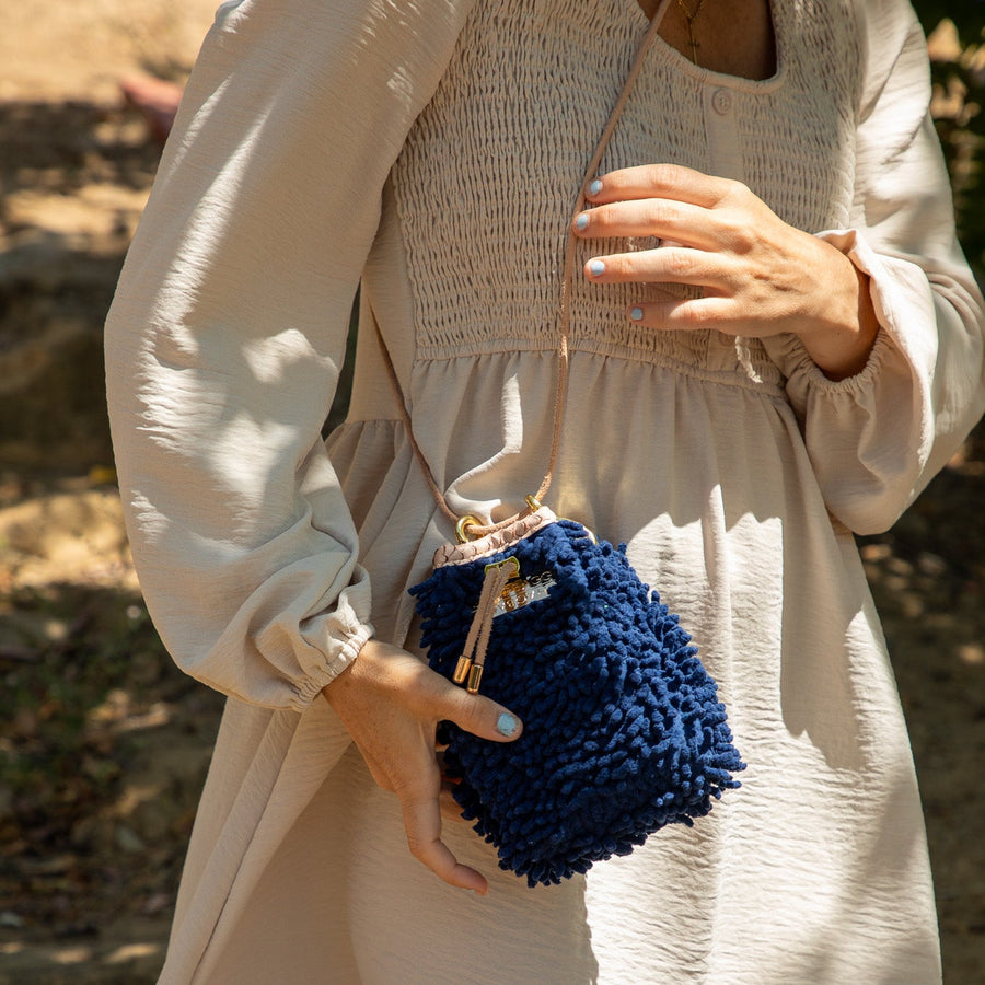 SHAGBAGG Drawstring Mini — Navy full SHAG crossbody bag with tan suede base and gold hardware, handmade Hollywood Los Angeles, front view