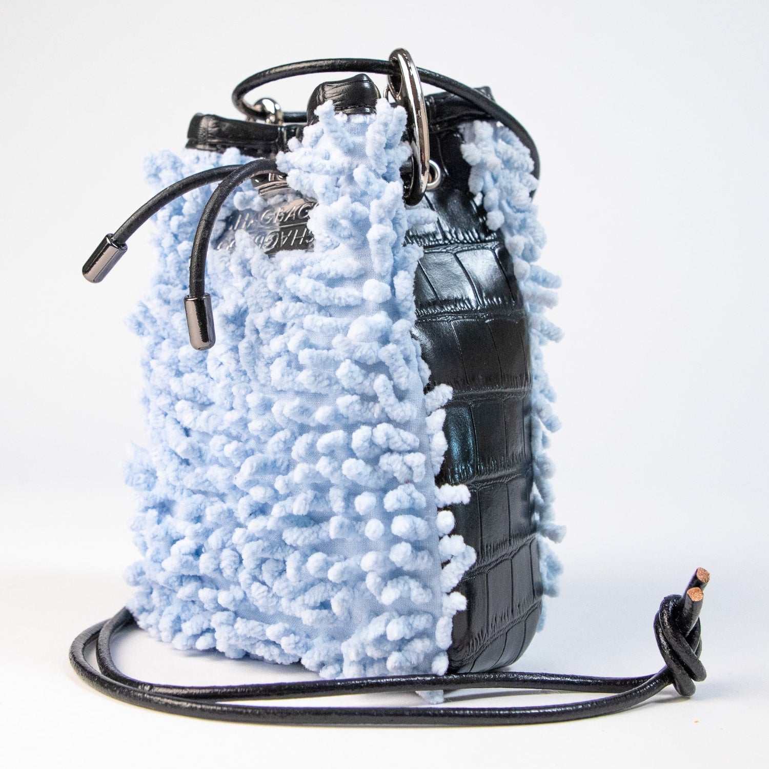 SHAGBAGG Drawstring Mini — Powdered Sky baby blue SHAG and glossy black faux croc 3 panel crossbody bag with silver hardware and black leather cord, handmade Hollywood Los Angeles, front view