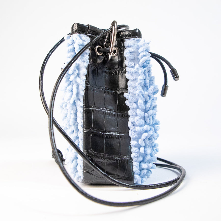 SHAGBAGG Drawstring Mini — Powdered Sky baby blue SHAG and glossy black faux croc 3 panel crossbody bag with silver hardware and black leather cord, handmade Hollywood Los Angeles, front view