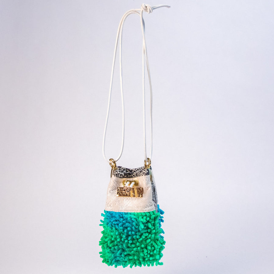 SHAGBAGG Mermaid Mini crossbody bag hanging — electric green and teal tie-dye SHAG, vintage lace, faux python, white leather strap, gold hardware
