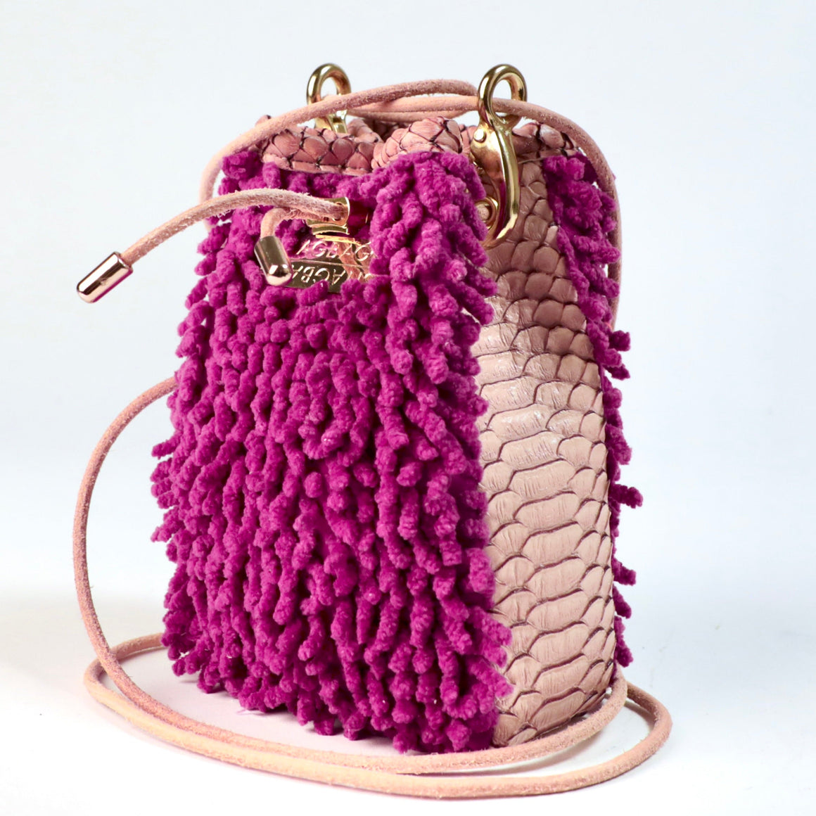 Orchid Ranch Drawstring SHAG Mini featuring orchid SHAG, tan faux python panels, gold-tone hardware, and a natural leather cord strap, handcrafted in Los Angeles.