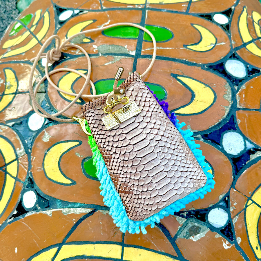 Rainbow Ranch Drawstring SHAG Mini featuring aqua, orchid, and green SHAG with tan faux python trim, gold-tone hardware, and a natural leather cord strap, handcrafted in Los Angeles