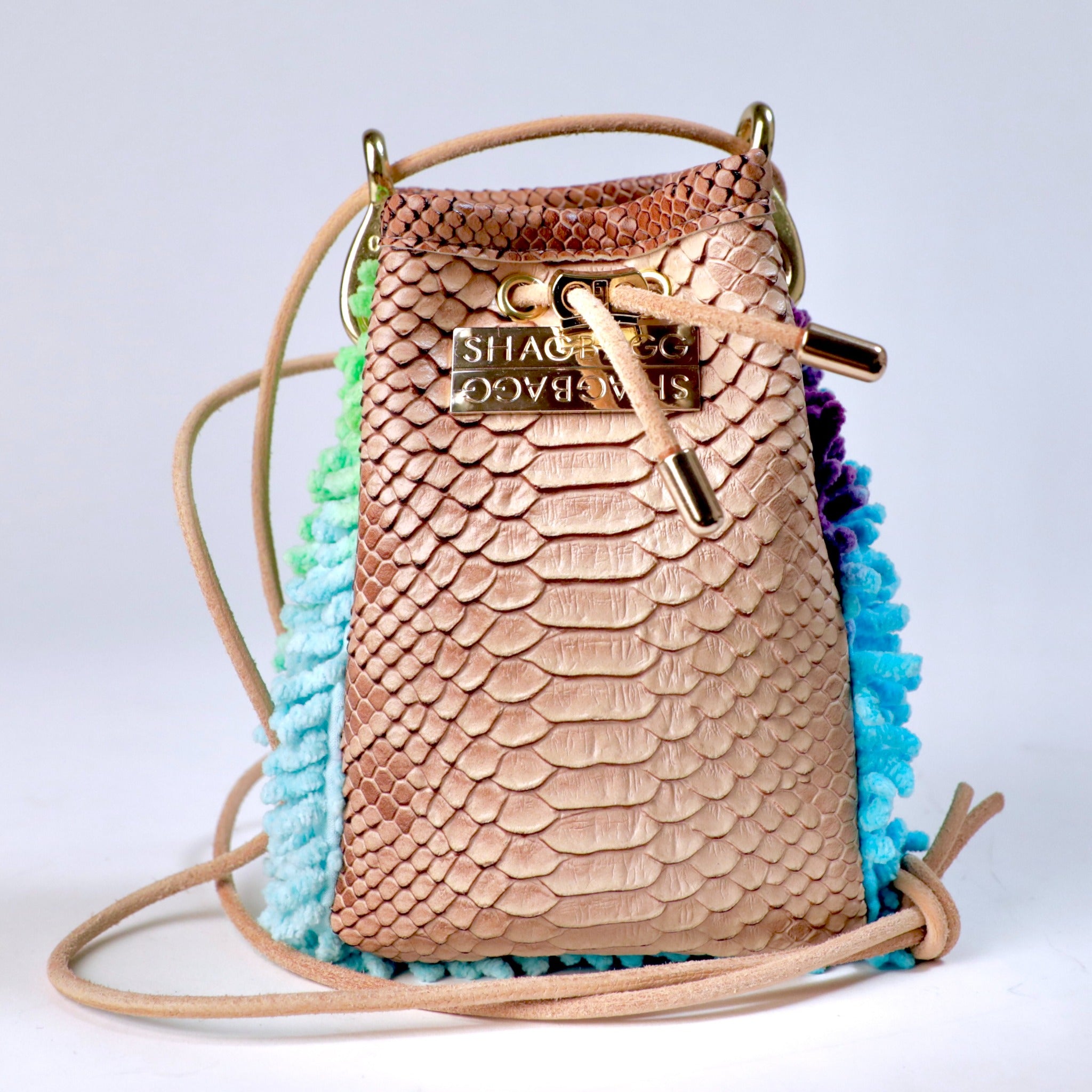 Rainbow Ranch Drawstring SHAG Mini featuring aqua, orchid, and green SHAG with tan faux python trim, gold-tone hardware, and a natural leather cord strap, handcrafted in Los Angeles