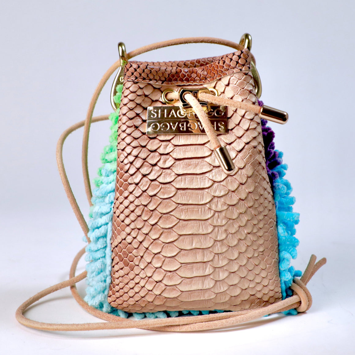 Rainbow Ranch Drawstring SHAG Mini featuring aqua, orchid, and green SHAG with tan faux python trim, gold-tone hardware, and a natural leather cord strap, handcrafted in Los Angeles