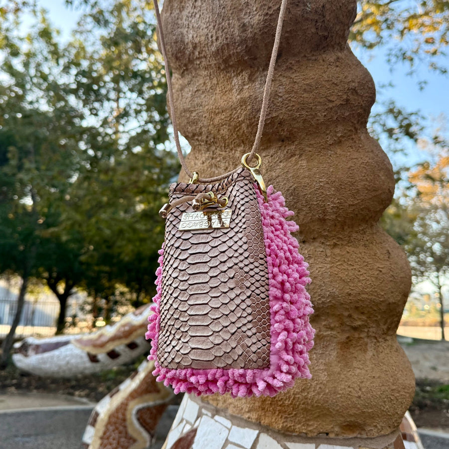 Rose Ranch Drawstring SHAG Mini shown with its full natural leather cord strap, featuring rose pink SHAG, tan faux python, and gold-tone hardware.