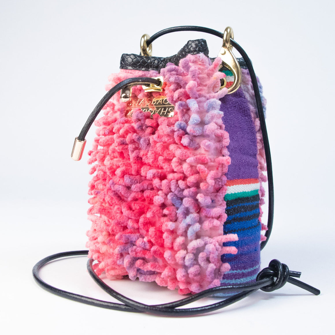 Hand-dyed SHAG Drawstring SHAG Mini with vintage woven textile panel, gold hardware, and black leather cord strap handcrafted in Los Angeles