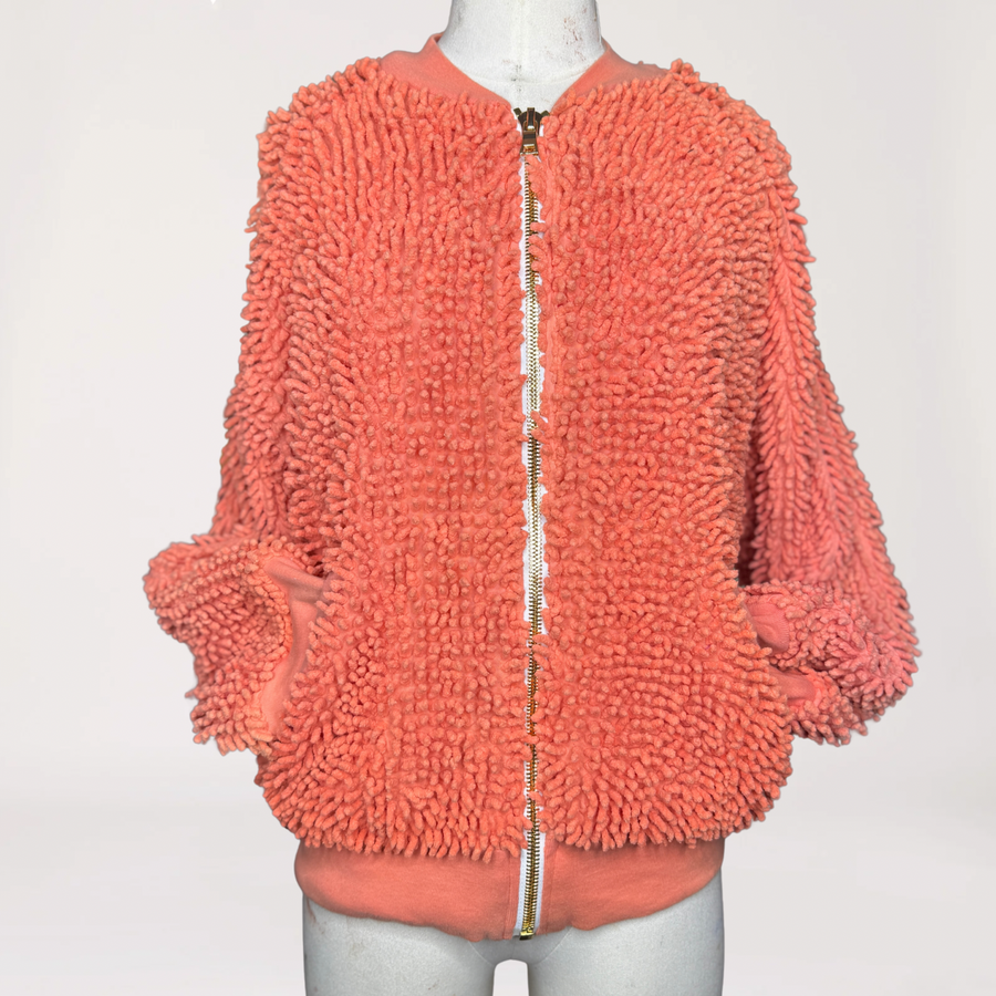 Close-up detail of the Tangerine SHAG bomber jacket collar and gold zipper by SHAGBAGG.