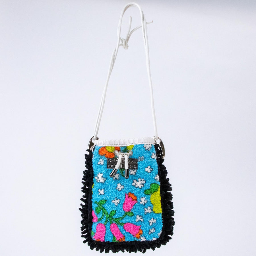 Trippy Garden at Midnight Drawstring SHAG Mini featuring archival turquoise floral terry, black SHAG, white faux python trim, silver-tone hardware, and a white leather cord strap, handcrafted in Los Angeles.